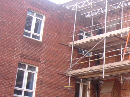 Gantry scaffolding forming a dropper or bridge over a fragile roof during renovation at St Mary's College, Blackpool